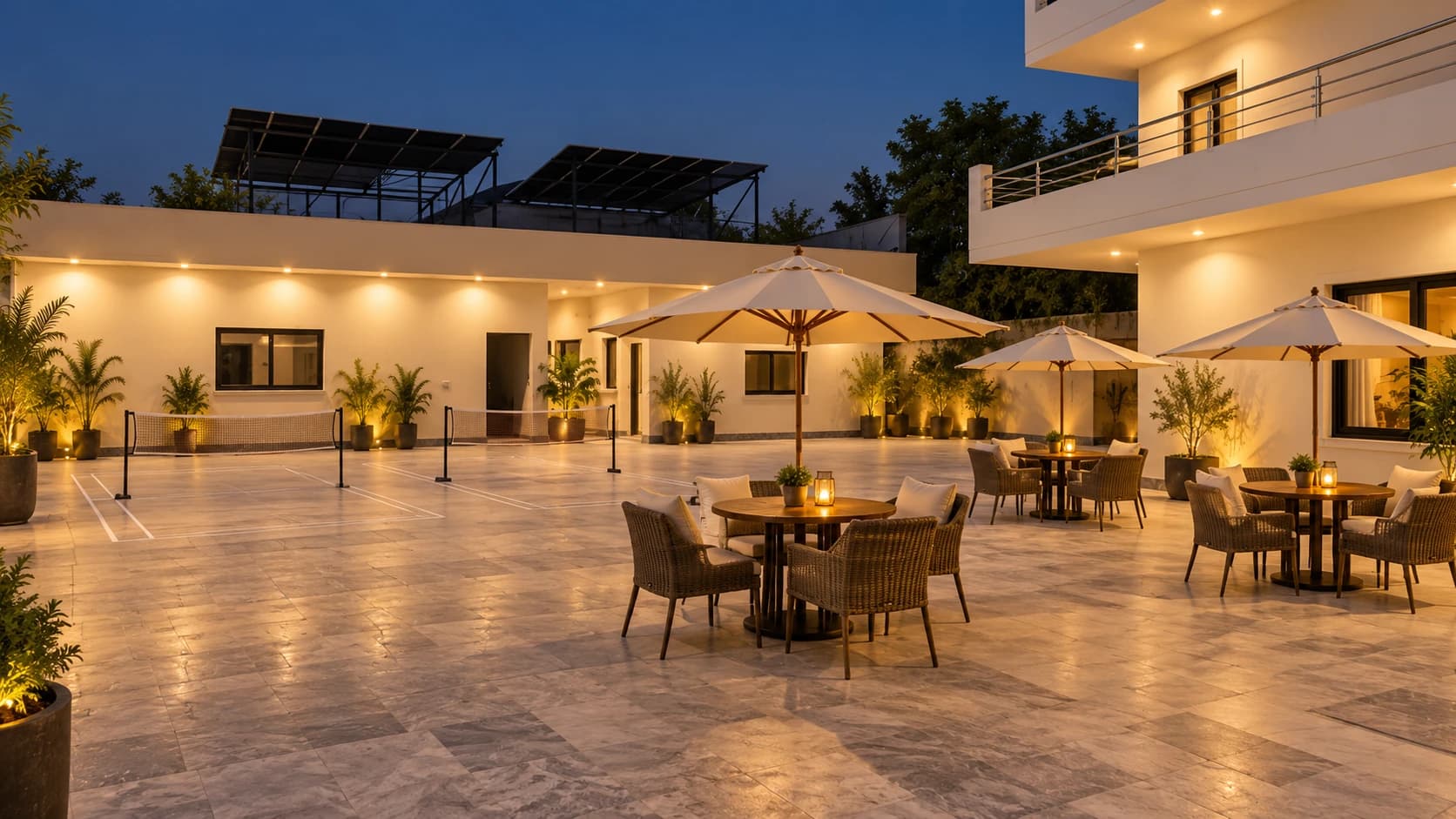 Courtyard with two side badminton nets and umbrella-covered outdoor seating