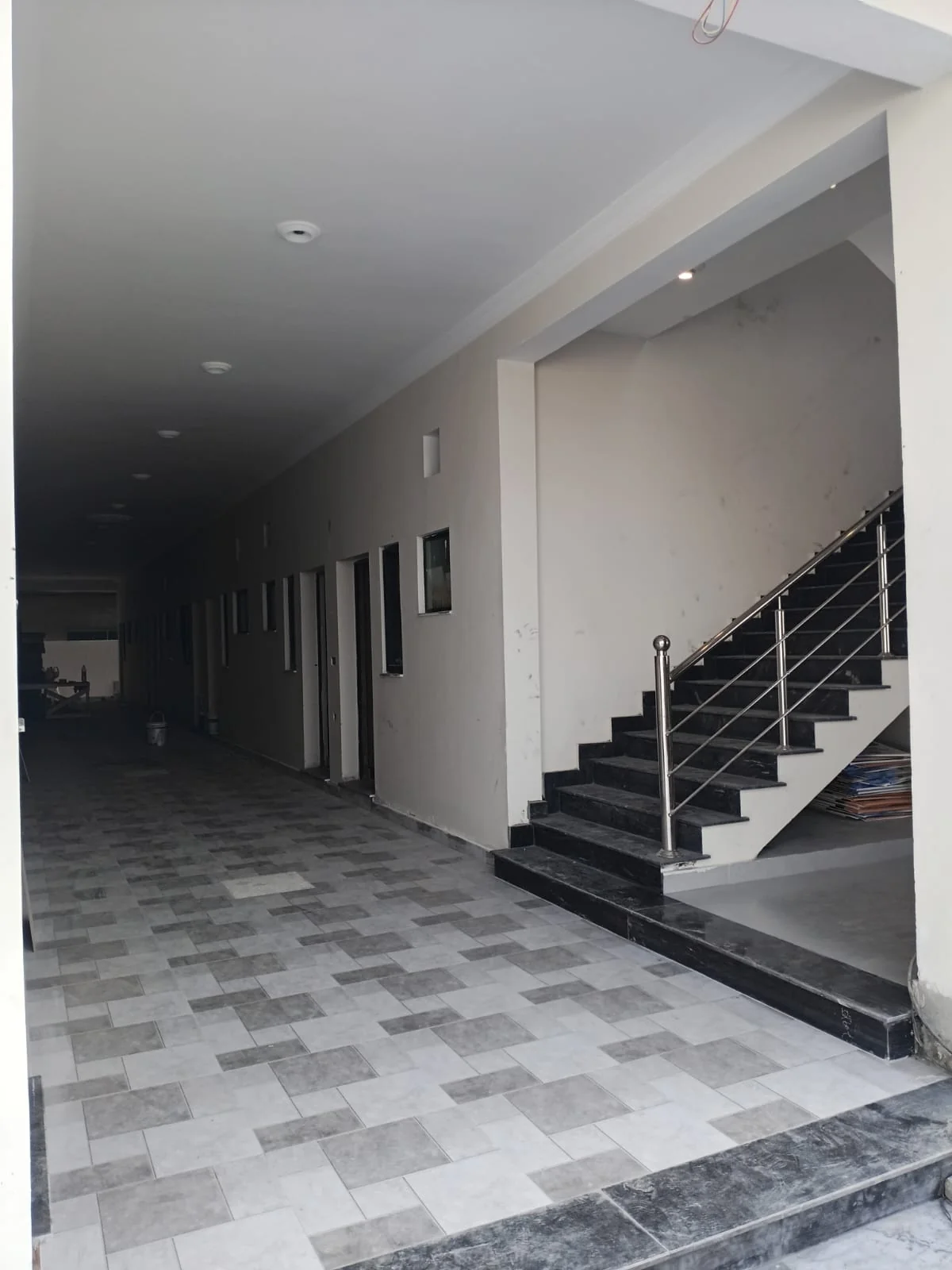 Tiled entrance with the staircase on the right and corridor ahead