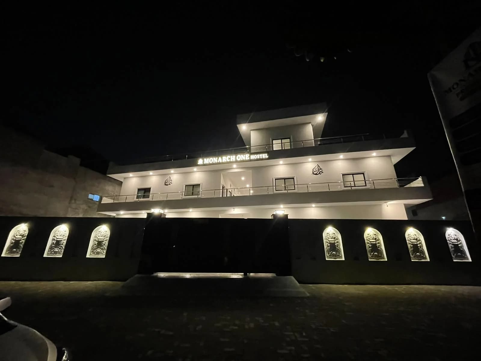 Monarch One's actual gated frontage illuminated at night